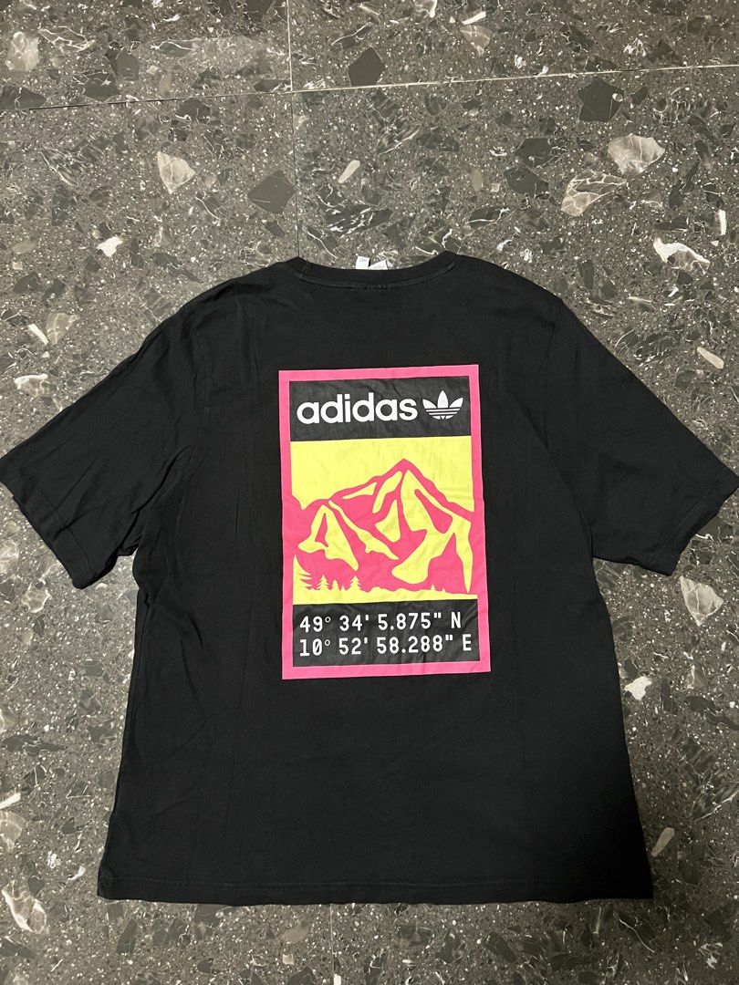 Adidas Graphic Tee Black Mountain Logo Size L (Category: Tshirts & Polo Shirts ) located in San Fernando. Submitted by justin_sy (Listing ID 1464887560, Image 2). Description: - Brand: Adidas - Color: Black - Size: L (Standard fit) - Material: 100% Cotton (Machine washable) - Design: Colorful mountain landscape patch on chest & large matching coordinate graphic print on back (49° 34' 5.875" N, 10° 52' 58.288" E) - Style: Classic crew neck, short 