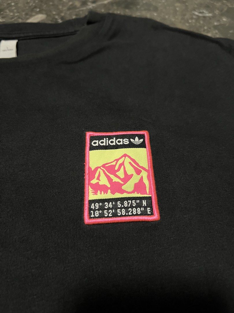 Adidas Graphic Tee Black Mountain Logo Size L (Category: Tshirts & Polo Shirts ) located in San Fernando. Submitted by justin_sy (Listing ID 1464887560, Image 3). Description: - Brand: Adidas - Color: Black - Size: L (Standard fit) - Material: 100% Cotton (Machine washable) - Design: Colorful mountain landscape patch on chest & large matching coordinate graphic print on back (49° 34' 5.875" N, 10° 52' 58.288" E) - Style: Classic crew neck, short 