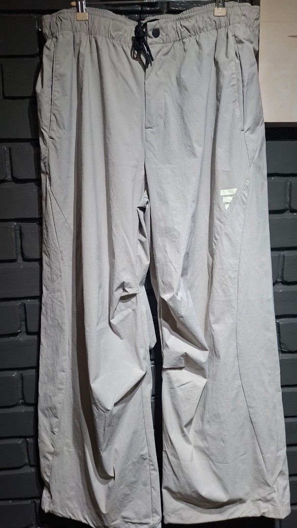Adidas Grey Nylon Track Pants (Category: Joggers) located in Davao. Submitted by rodrigoani57168 (Listing ID 1464890084, Image 2). Description: - Brand: Adidas - Color: Light Grey - Material: Lightweight nylon - Waistband: Elastic with adjustable drawstring - Design: Classic Adidas logo near right hip, clean hem details - Fit: Relaxed fit - Ideal for: Workouts or casual streetwear - Adidas track pants - Size: 2XL -Color: Light Grey -Features Adid