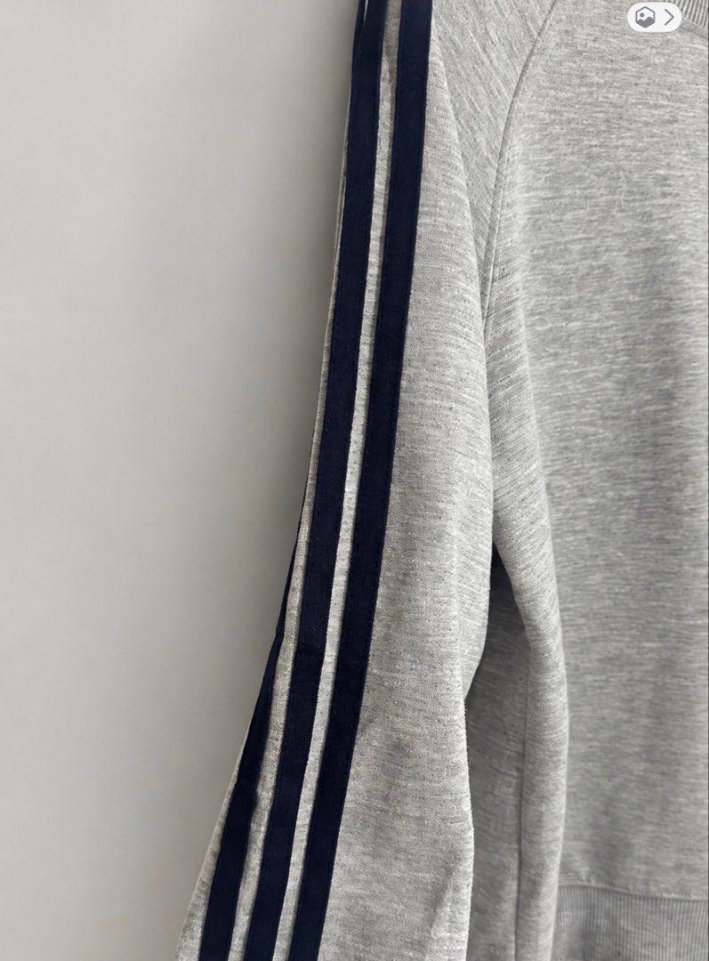 Adidas Grey Three-Stripe Sweatshirt (Category: Coats, Jackets and Outerwear) located in Marikina City. Submitted by xyrezsani (Listing ID 1464901070, Image 3). Description: - Brand: Adidas - Color: Grey with black three-stripe detailing - Design: Classic crewneck, ribbed cuffs and hem - Logo: Small printed Adidas logo on chest and emblem near collar - Fit: Comfortable for everyday casual wear - Condition: Brand new / Excellent (ready to ship).