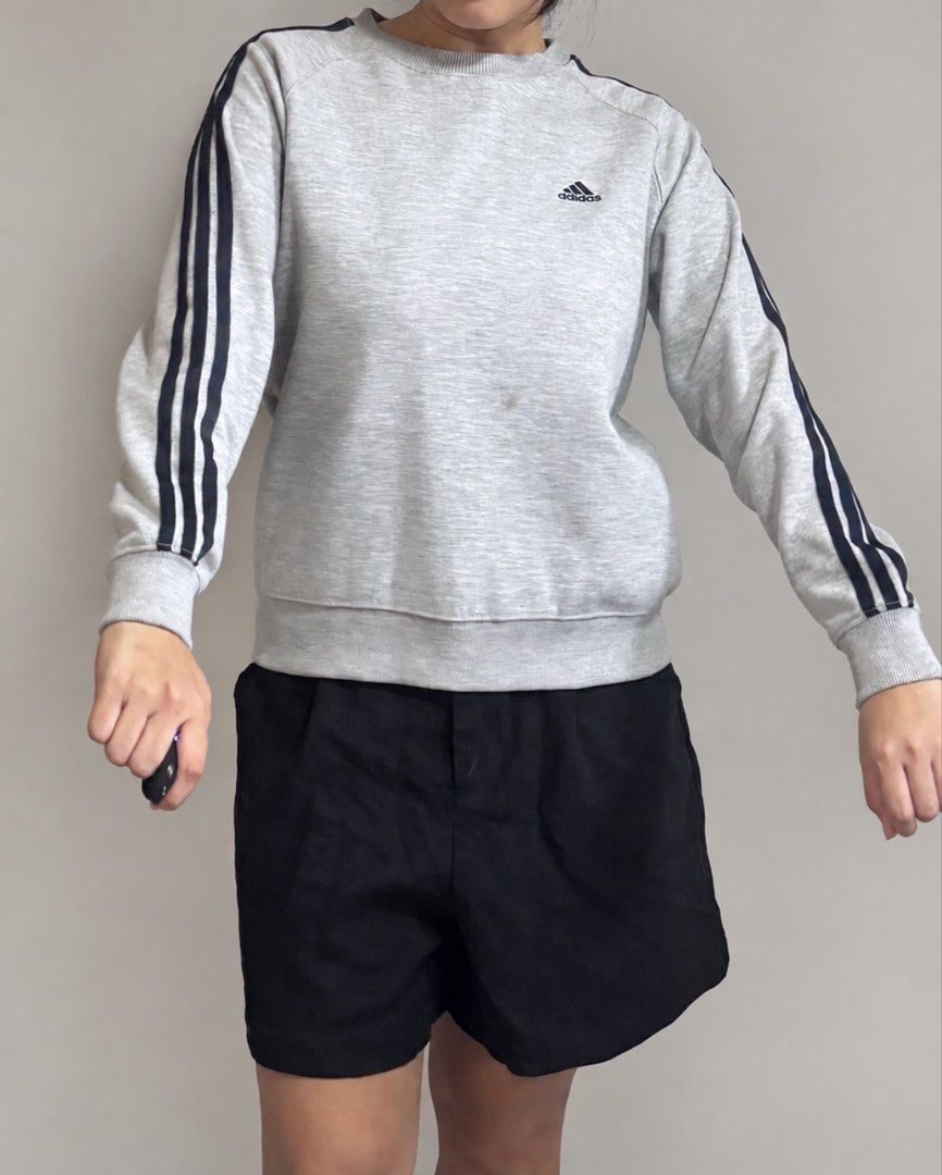 Adidas Grey Three-Stripe Sweatshirt (Category: Coats, Jackets and Outerwear) located in Marikina City. Submitted by xyrezsani (Listing ID 1464901070, Image 1). Description: - Brand: Adidas - Color: Grey with black three-stripe detailing - Design: Classic crewneck, ribbed cuffs and hem - Logo: Small printed Adidas logo on chest and emblem near collar - Fit: Comfortable for everyday casual wear - Condition: Brand new / Excellent (ready to ship).
