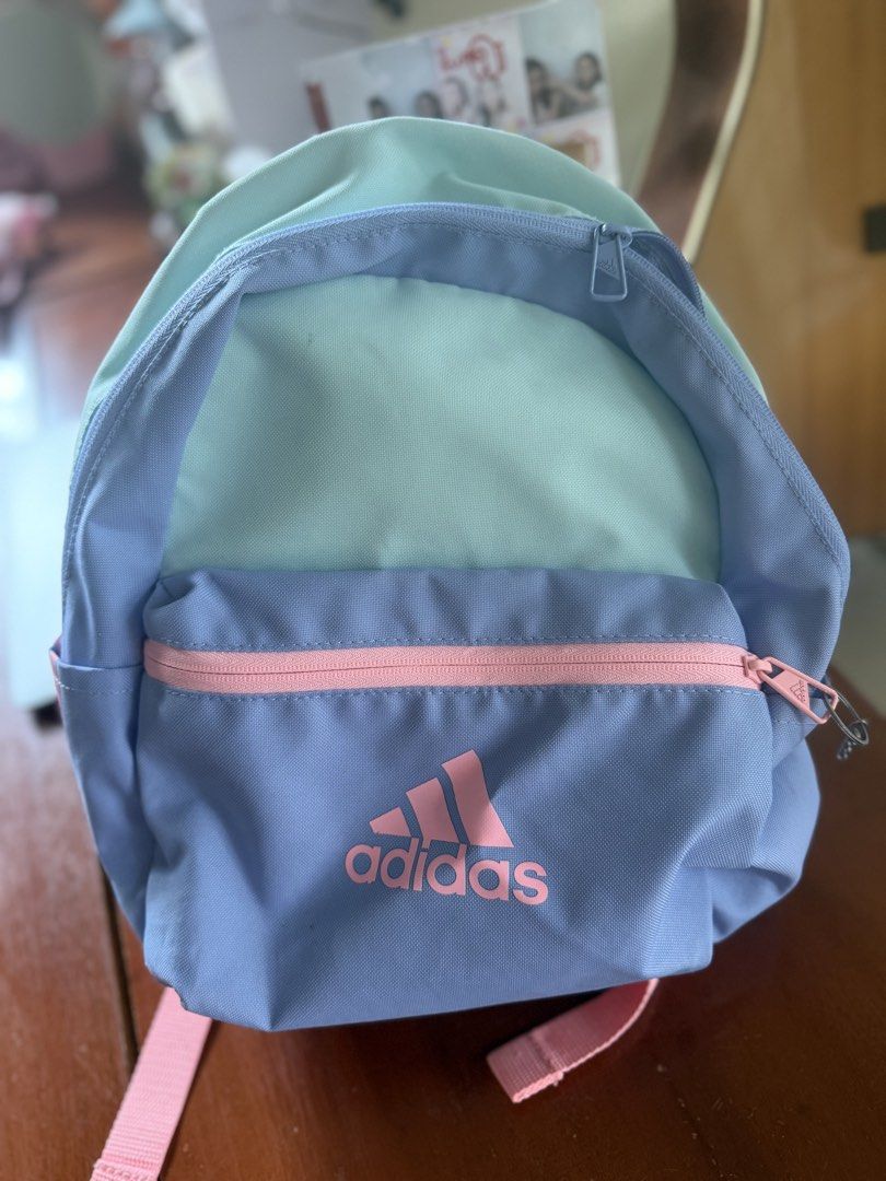 Adidas Pastel Multicolor Mini Backpack (Category: Backpacks) located in Angeles City. Submitted by reginageorge22 (Listing ID 1464847931, Image 1). Description: - Brand: Adidas - Design: Multicolor pastel (mint green, light blue, and pink accents) - Storage: Main compartment + front zip pocket for small essentials - Straps: Adjustable shoulder straps with matching details - Use: Ideal for daily use, school, or casual outings Used by a child See s