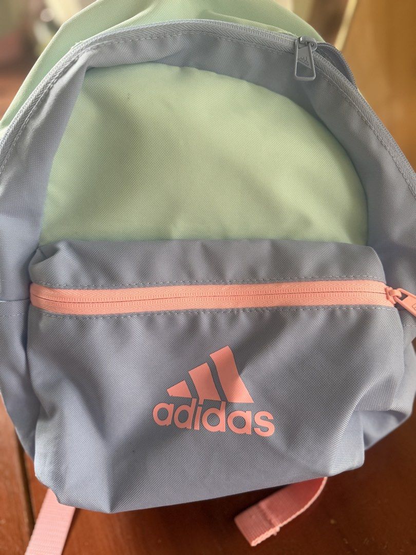 Adidas Pastel Multicolor Mini Backpack (Category: Backpacks) located in Angeles City. Submitted by reginageorge22 (Listing ID 1464847931, Image 2). Description: - Brand: Adidas - Design: Multicolor pastel (mint green, light blue, and pink accents) - Storage: Main compartment + front zip pocket for small essentials - Straps: Adjustable shoulder straps with matching details - Use: Ideal for daily use, school, or casual outings Used by a child See s