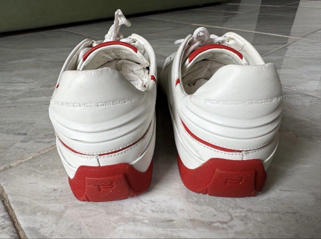 Adidas Porsche Design White Red Sneakers (Category: Casual Shoes) located in Binan City. Submitted by itiantimbol27 (Listing ID 1464894772, Image 2). Description: - Authentic Porsche Design sneakers in white leather with vibrant red accents and soles - Chunky rounded silhouette with a stylish driving shoe aesthetic - Features embossed Porsche Design branding on the heel and printed insoles - Textured outsole for reliable grip - Excellent pre-love