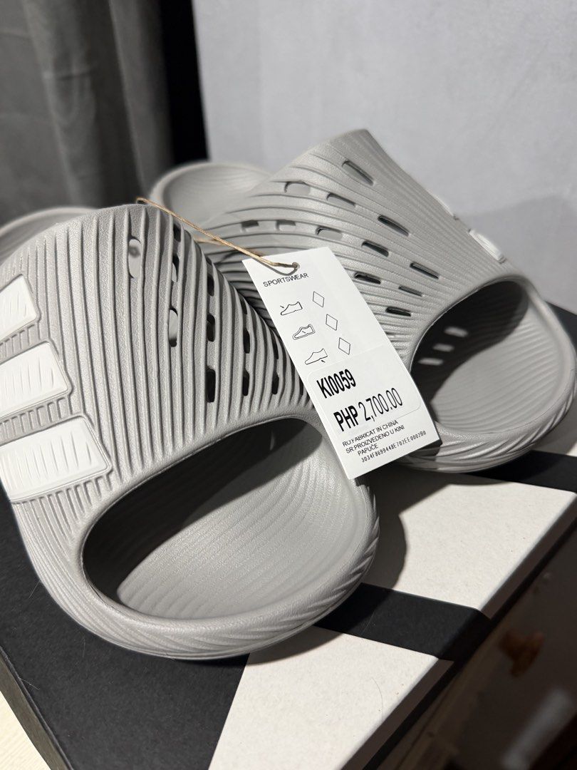 Adidas Purechill Slide Grey Size 5 US (Category: Slippers and slides) located in Taguig. Submitted by amiwear (Listing ID 1464934034, Image 1). Description: - Brand: Adidas Purechill Slides - Color: Grey with white stripes - Size: 5 US / 38 EU / 23.5 JP - Condition: Brand new with original tags - Design: All-over ribbed texture with side ventilation cutouts - Comfort: Slip-on style, super comfortable for casual days or post-workout RFS: Extra pai