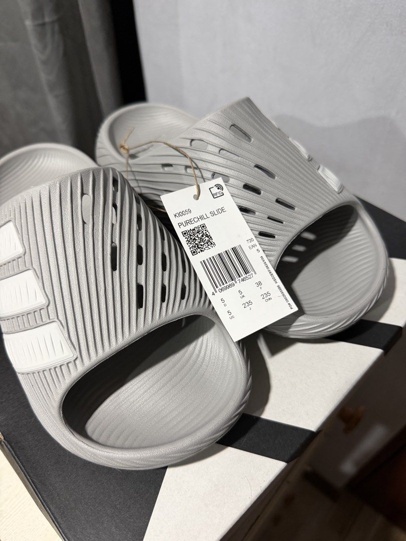 Adidas Purechill Slide Grey Size 5 US (Category: Slippers and slides) located in Taguig. Submitted by amiwear (Listing ID 1464934034, Image 2). Description: - Brand: Adidas Purechill Slides - Color: Grey with white stripes - Size: 5 US / 38 EU / 23.5 JP - Condition: Brand new with original tags - Design: All-over ribbed texture with side ventilation cutouts - Comfort: Slip-on style, super comfortable for casual days or post-workout RFS: Extra pai