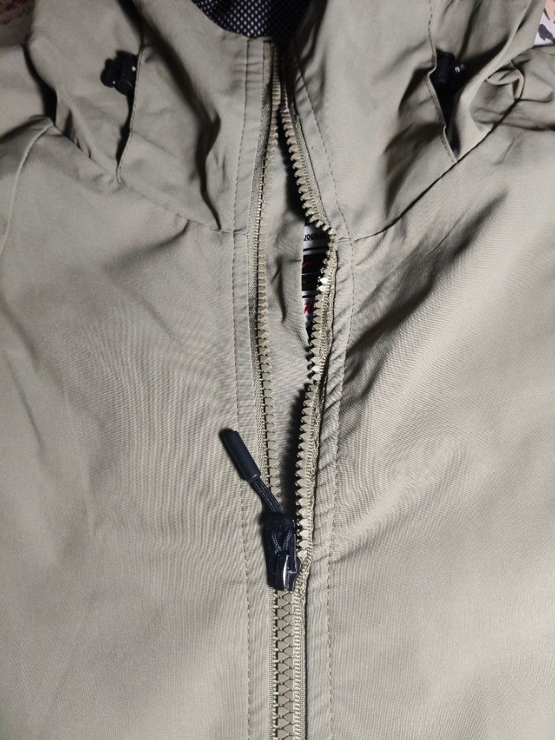 Adventure Wind Breaker (Category: Coats, Jackets and Outerwear) located in Lapu Lapu. Submitted by hooman422 (Listing ID 1464917989, Image 3). Description: • Style: Technical hooded windbreaker or light rain jacket. • Color: Matte olive drab / khaki green. • Closure: Full-length front zipper with an extended chin guard. • Hood: Attached hood with adjustable elastic drawcords and a dark mesh lining. • Pockets: Four front zippered pockets, includin