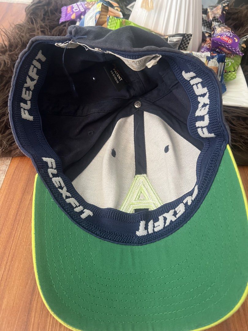 Aeropostale Flexfit Letter A Hat (Category: Caps & Hats) located in Manila. Submitted by declutteringlangpo (Listing ID 1464780500, Image 3). Description: - Brand: Aeropostale - Color: Navy blue with neon green brim and top button - Design: Large embroidered white and green 'A' logo on the front - Size: L/XL with Flexfit stretch band for a snug, comfortable fit - Material: Cotton and polyester blend - Condition: Brand new with tags inside.