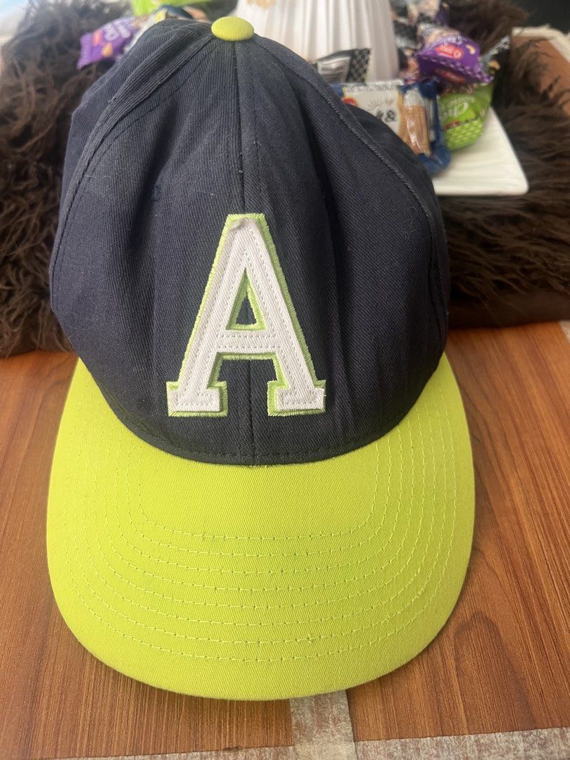 Aeropostale Flexfit Letter A Hat (Category: Caps & Hats) located in Manila. Submitted by declutteringlangpo (Listing ID 1464780500, Image 1). Description: - Brand: Aeropostale - Color: Navy blue with neon green brim and top button - Design: Large embroidered white and green 'A' logo on the front - Size: L/XL with Flexfit stretch band for a snug, comfortable fit - Material: Cotton and polyester blend - Condition: Brand new with tags inside.