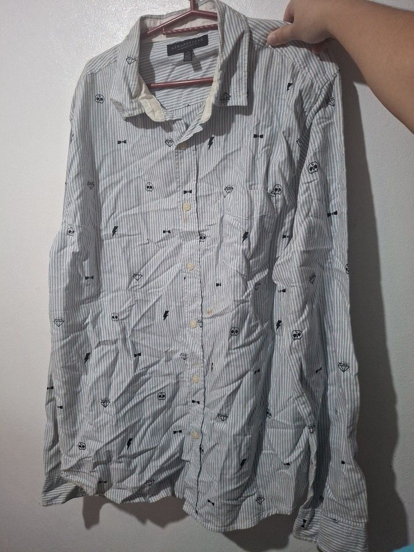 Aeropostale Patterned Striped Long Sleeve Button-Up Shirt (Category: Longsleeves) located in Quezon City. Submitted by 042361 (Listing ID 1464803356, Image 1). Description: - Brand: Aeropostale - Style: Long sleeve button-up shirt - Design: Light grey & white stripes with all-over skull, diamond, & lightning bolt pattern - Details: Classic collar, front button closure, and chest pocket - Fit: Regular fit - Condition: Great for casual everyday wea