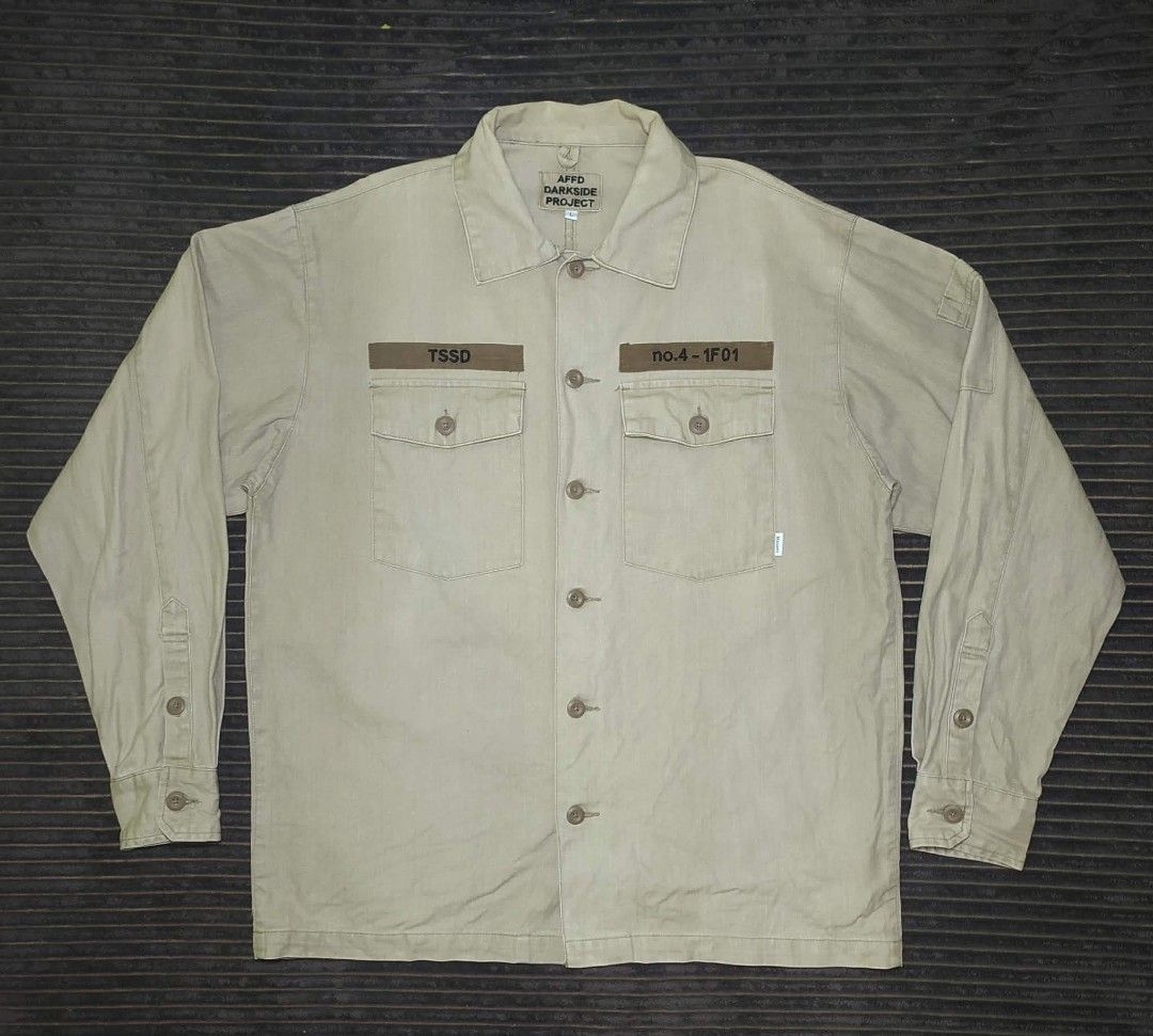 AFFD Darkside Project Utility Shirt Khaki Size L (Category: Tshirts & Polo Shirts ) located in Manila. Submitted by norathrifted (Listing ID 1464792318, Image 1). Description: - Brand/Model: AFFD Darkside Project - Size: Large - Color: Khaki - Material: Structured cotton - Closure: Button-front with matching brown buttons - Pockets: Two chest pockets with button flaps - Details: Printed lettering above both pockets, classic collar, and long sleev