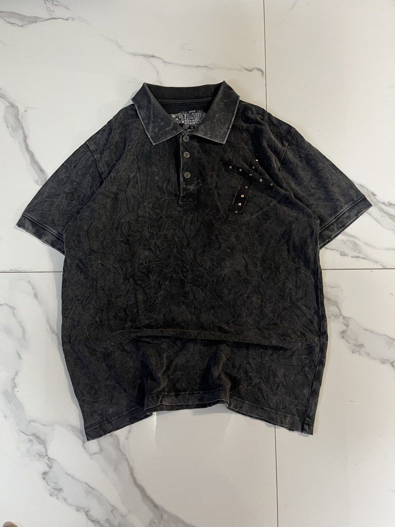 Affliction alt polo wings (Category: Tshirts & Polo Shirts ) located in Caloocan City. Submitted by crucifiedtearz (Listing ID 1464782243, Image 1). Description: - Brand: Sail Soho - Color: Black acid wash - Size: Medium - Style: Short sleeve polo with 3-button placket - Front Detail: Embellished studded cross design on the left chest - Back Detail: Large, detailed graphic featuring wings, skulls, a shield, and a studded cross with pink scrollwor