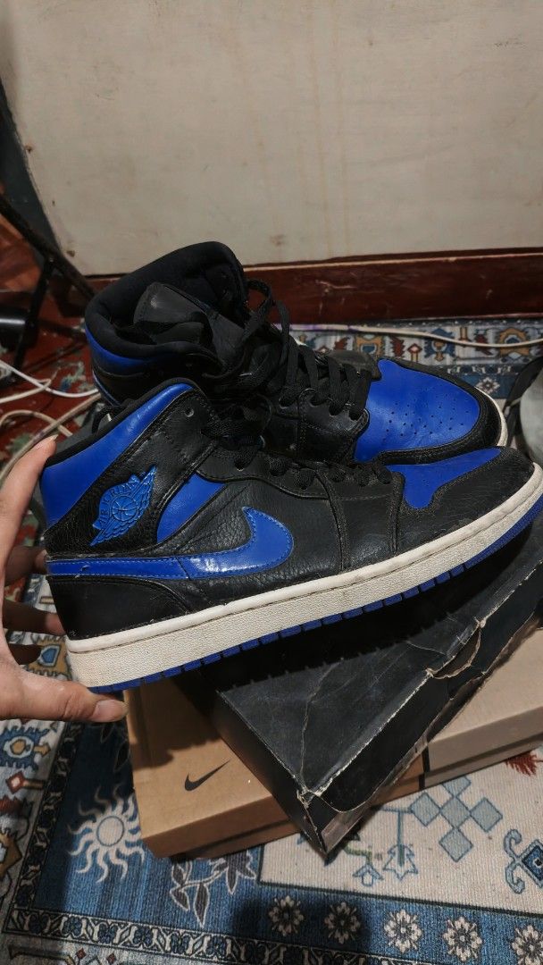 Air Jordan 1 Mid Royal Blue Black (Category: Sneakers) located in Manila. Submitted by zy0420 (Listing ID 1464877554, Image 2). Description: - Model: Air Jordan 1 Mid (Black and Royal Blue) - Material: Premium tumbled leather upper with contrast blue toe box - Condition: leather starting crack, minor wear on sole edges - Inclusion: Original black Jordan box included - Mode of Payment: GCash or BPI - Shipping: MOP via J&T (Buyer shoulders fee) / M