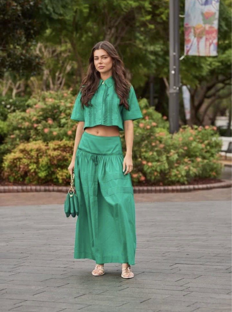 Aje Emerald Tidal Tucked Crop Top (Category: Shirts) located in Iloilo. Submitted by ele.girl (Listing ID 1464902086, Image 1). Description: - Brand: Aje - Color: Bright green - Style: Short sleeve crop top - Details: Unique pleated detailing along the front button placket - Fit: Structured fabric that holds its shape, hits right at the waistline - Condition: Great statement piece for warm weather.