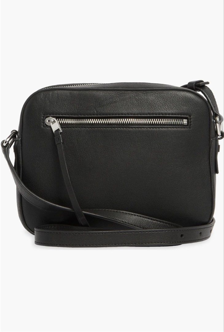 All Saints Captain Leather Camera Bag (Category: Luxury Bags & Wallets) located in Quezon City. Submitted by arterg (Listing ID 1464881717, Image 2). Description: Bought US 2025 9/10 • Material: Premium, textured pebbled cow leather. • Design: A minimalist, boxy silhouette featuring double top-zipper compartments, long leather zipper pulls, and silver-tone hardware accents. • Strap: An adjustable skinny leather crossbody strap secured with metal 