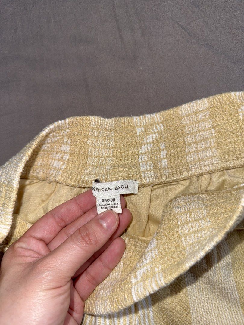 American Eagle Yellow Striped Ruffle Shorts Size Small (Category: Shorts) located in Santa Ana. Submitted by fatikilla (Listing ID 1464810507, Image 2). Description: - Brand: American Eagle - Size: Small (tag attached) - Color/Pattern: Yellow and white stripes - Waistband: Smocked high-rise elastic - Fit & Style: Flowy with ruffled hems, fully lined - Origin: Made in India - Condition: Great casual piece for warm weather.