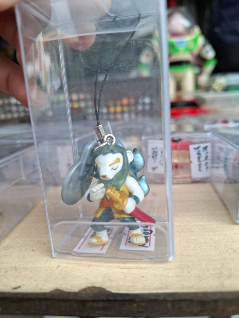 Anime Character Strap Figurine Keychain Phone Charm (Category: Character Goods) located in Manila. Submitted by rocksolid227 (Listing ID 1464822936, Image 3). Description: - Cute blue-haired anime character with sword figurine - Attached to a black strap with a secure silver clasp - Includes a stylish grey coin-like accessory - Comes inside a clear protective display case - Ideal for anime fans and merchandise collectors.