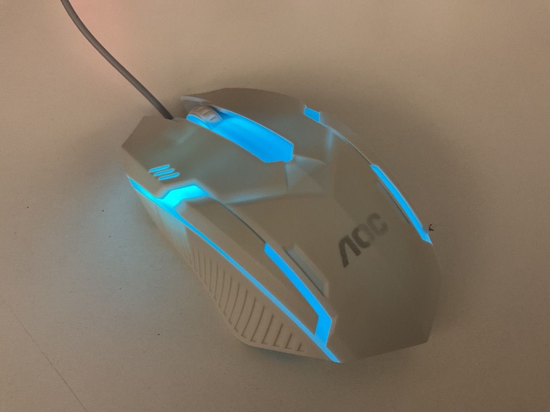 AOC wired gaming mouse with blue LED backlighting （分類：電腦滑鼠及相關產品）位於 Hong Kong。 由 tel6683qs2296 提交（商品編號 1464874361，圖片 1）。簡介： - Brand: AOC - Type: Wired USB gaming mouse - Color: White with striking blue LED accents - Design: Ergonomic textured side grips for better hold - Condition: Clean surface, fully working lights - Delivery: Ready for pickup or MTR meet-up NO REDUNDS。