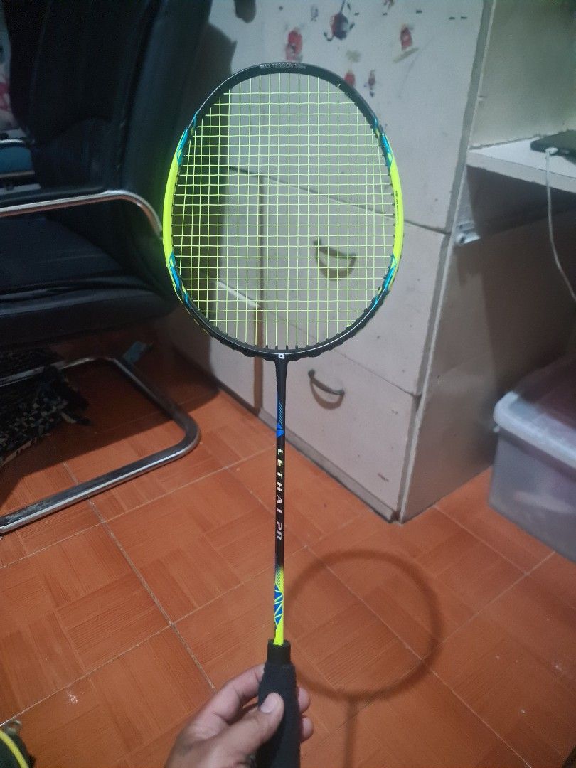 Apacs Lethal 28 Badminton Racket (Category: Racket and Ball Sports) located in Manila. Submitted by josejhayco69373 (Listing ID 1464868905, Image 2). Description: - Model: Apacs Lethal 28 Badminton Racket - Performance: Excellent power and durability, perfect for intermediate to advanced players - Strings: Neon yellow string with a maximum tension of 35lbs - Grip: Black grip tape newly wrapped on the handle - Inclusion: Matching black Apacs zip c