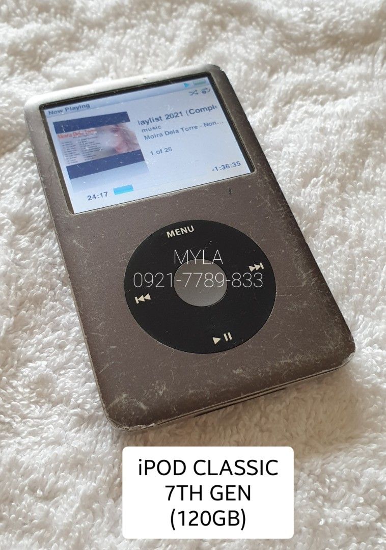 Apple iPod Classic 7th Generation 120GB MP3 Player (Category: Portable Music Players) located in Lucena. Submitted by lucenasecondhanditems (Listing ID 1464839714, Image 2). Description: - Model: Apple iPod Classic 7th Gen (120GB storage) - Battery Life: Approx. 5 hours on a full charge - Condition: Heavy cosmetic wear with visible dents and scratches all over - Functionality: Click wheel, headphone port, and dock connector work normally (Note: H