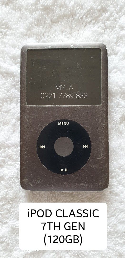 Apple iPod Classic 7th Generation 120GB MP3 Player (Category: Portable Music Players) located in Lucena. Submitted by lucenasecondhanditems (Listing ID 1464839714, Image 3). Description: - Model: Apple iPod Classic 7th Gen (120GB storage) - Battery Life: Approx. 5 hours on a full charge - Condition: Heavy cosmetic wear with visible dents and scratches all over - Functionality: Click wheel, headphone port, and dock connector work normally (Note: H