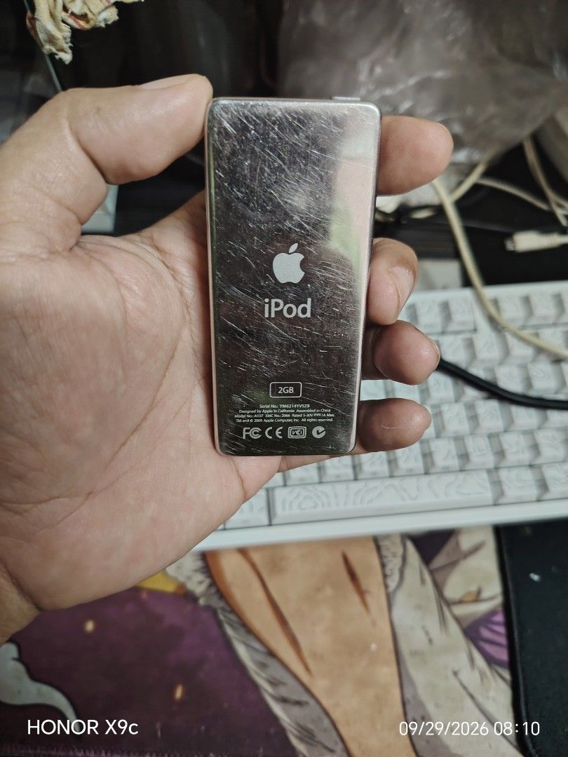 Apple iPod nano 2GB White (Category: Portable Music Players) located in Manila. Submitted by flashghie (Listing ID 1464965031, Image 2). Description: - Model: Apple iPod nano (White) - Storage: 2GB capacity - Features: Classic click wheel design & custom Rockbox firmware - Condition: Screen turns on, fully functional, with visible scratches on the chrome back from regular use - Included: Portable music player ready for your tunes.