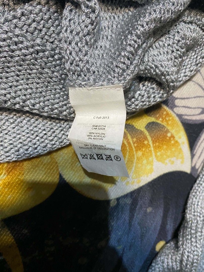 Armani Exchange Grey Knit Sweater (Category: Longsleeves) located in Manila. Submitted by thrift_sta.20 (Listing ID 1464876018, Image 3). Description: - Brand: Armani Exchange - Item: Women's Knit Sweater - Color: Grey - Size: S/M - Material: 52% nylon, 45% acrylic, 3% rayon - Features: Long sleeves, open neckline, structured ribbon collar accent - Condition: Brand new with original thrift store tag attached - Care: Dry clean only - Origin: Made 
