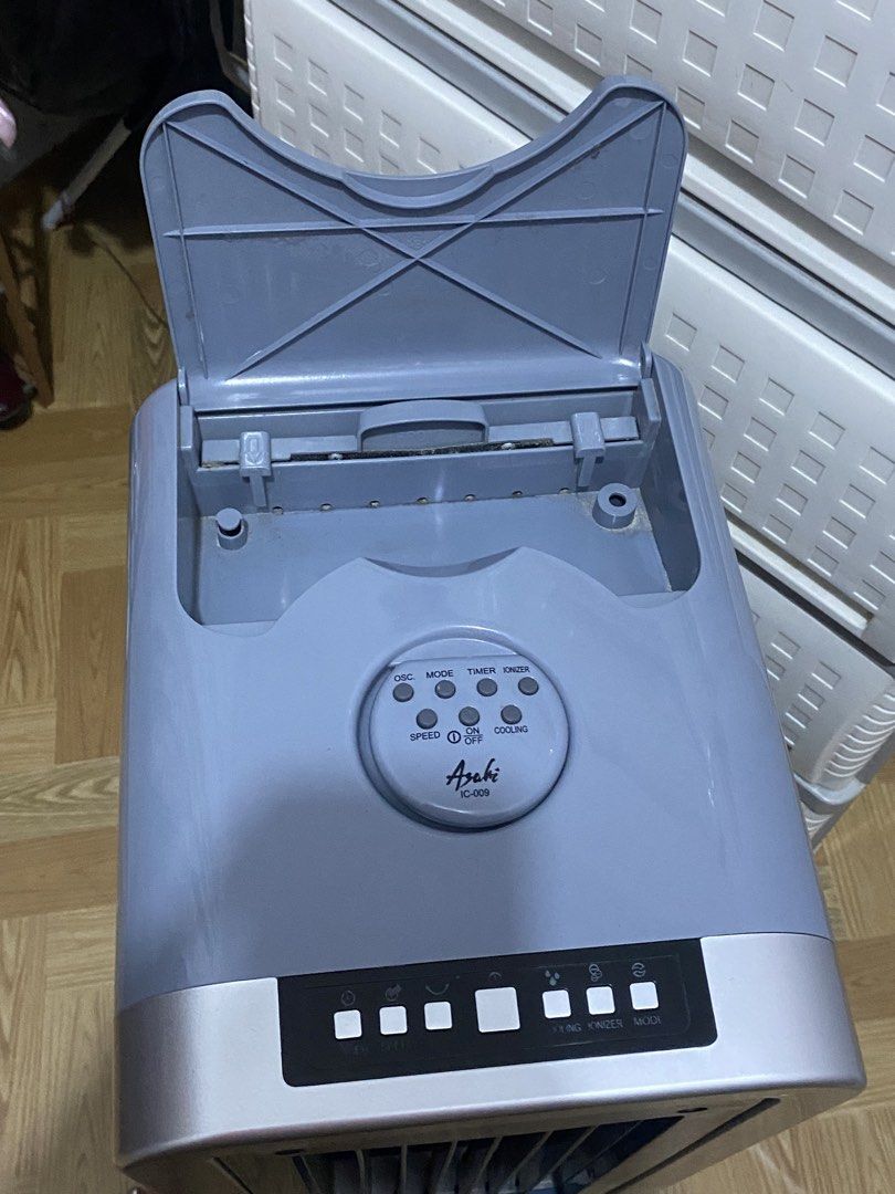 Asahi IC-009 Air Cooler (Category: Air Conditioning and Heating) located in Quezon City. Submitted by 4riazuki (Listing ID 1464864373, Image 3). Description: - Brand/Model: Asahi Air Cooler IC-009 - Color: Stylish grey and blue - Features: Top and front control panels, oscillation, multiple modes, timer, ionizer, and cooling function - Convenience: Equipped with bottom wheels for easy mobility, a top-opening water compartment, and a fully opening