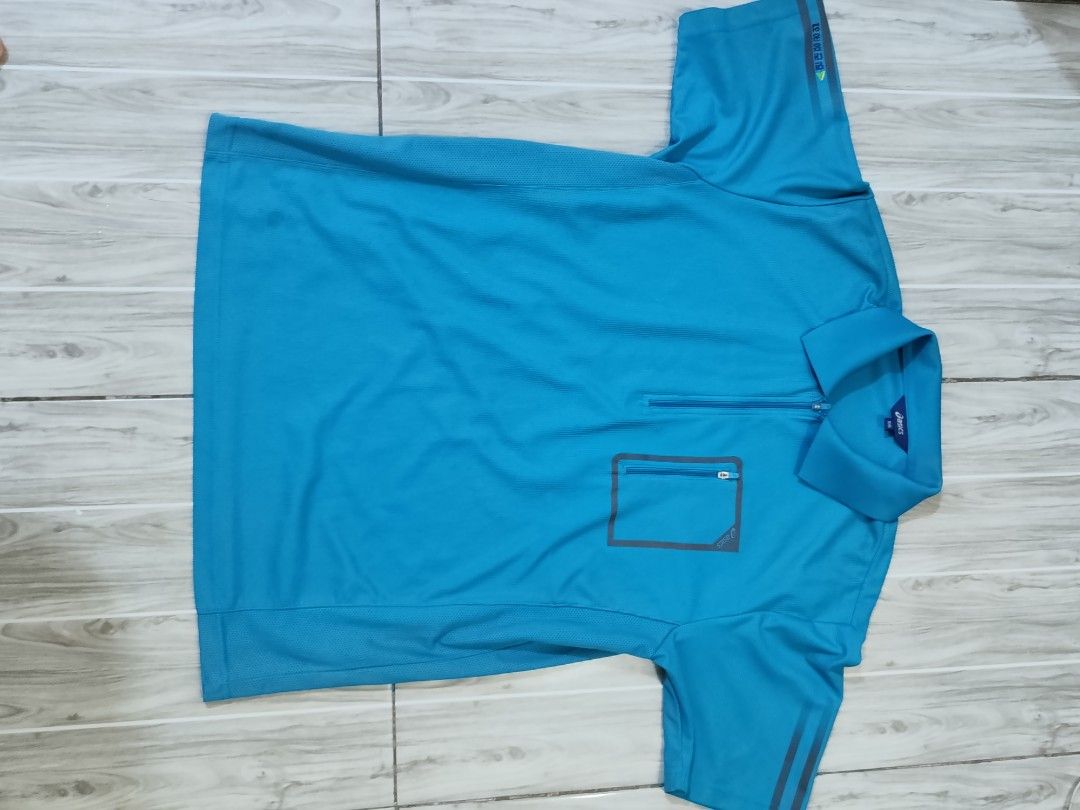 Asics Blue Polo Shirt Size 105 (Category: Tshirts & Polo Shirts ) located in Caloocan City. Submitted by moneyhunt25 (Listing ID 1464854261, Image 2). Description: - Brand: Asics - Color: Blue - Size: 105 (Tag inside) - Design: Short-sleeve polo with front zip collar and chest pocket - Material: Breathable athletic fabric - Condition: Good option for workouts or casual wear.