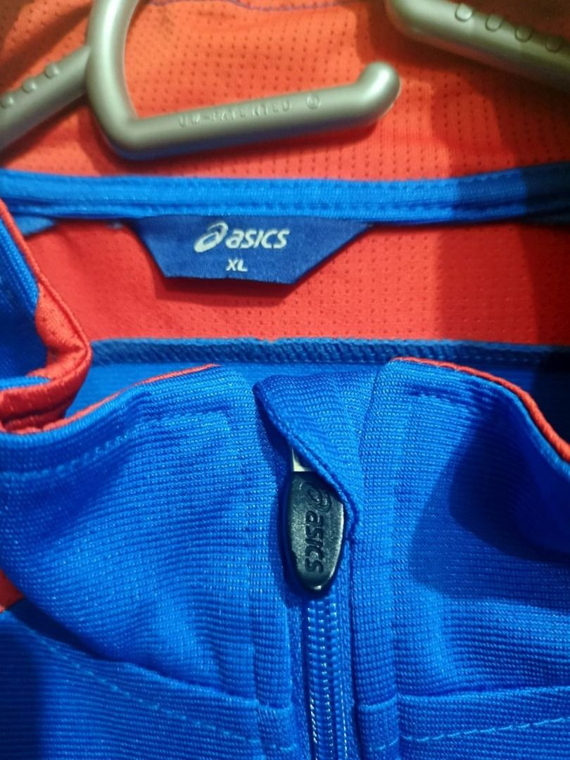Asics Vintage Athletic Track Jacket (Category: Coats, Jackets and Outerwear) located in Taguig. Submitted by wenwen_21 (Listing ID 1464925873, Image 3). Description: Vintage Asics zip-up athletic track jacket in bold royal blue with red and navy accents. Features the embroidered Asics logo on the chest, printed stripe graphics along the shoulders, and custom branding near the lower hem. Style: Full-Zip Track Jacket / Sportswear Color: Royal Blue 