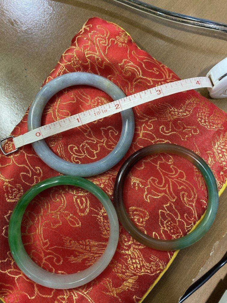 Assorted Jadeite and Agate Bangles Set of Three (Category: Bracelets) located in Quezon City. Submitted by gab_tan (Listing ID 1464895337, Image 2). Description: - Set of 3 traditional polished bangles displayed with a red embroidered pouch - Lavender jadeite bangle measures approx. 3 inches across the inner diameter (measured with tape) - Includes one classic green and white jadeite bangle - Includes one rich multi-colored dark green and brown a