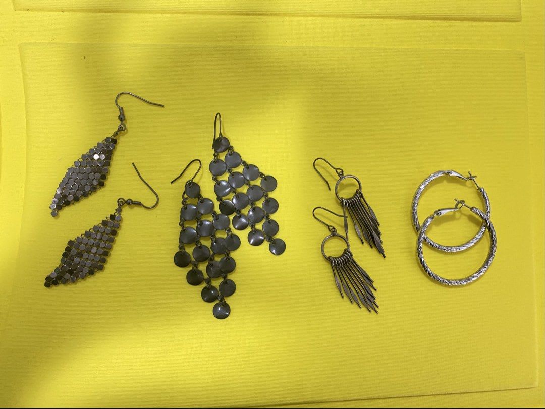 Assorted Statement Earrings (Category: Earrings) located in Singapore. Submitted by dustykate (Listing ID 1464829435, Image 1). Description: - trendy earrings in dark gunmetal grey and silver - price left to right; 1) $10 2) $15 3)$10 4)$12 - Includes 4 distinct styles: diamond mesh dangles, cascading coin dangles, fringe hoops, and textured silver hoops - Designed with secure hook and clasp closures - Great variety for mixing and matching with c