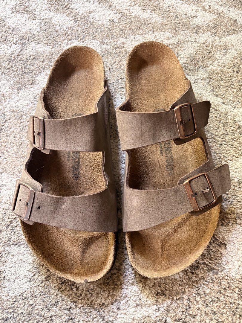 Auth Preloved Birkenstock Arizona Mocha (Category: Slippers & Slides) located in Paranaque City. Submitted by silentstone.dolphin (Listing ID 1464770626, Image 2). Description: Classic Mocha Color.. Brass Buckle.. Visible Print.. Size 45RF.. All time favorite🥳 Best Seller‼️ Clean&Ready to Wear✅ Super Gwapo in Actual!😍.
