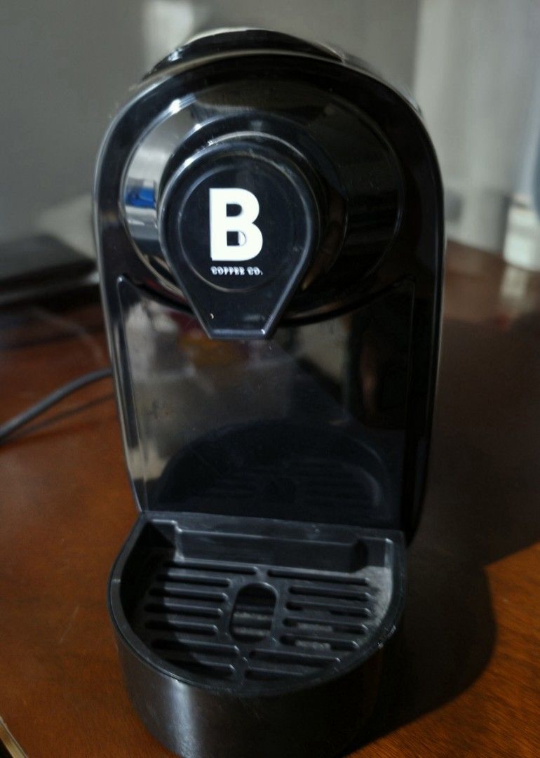B Coffee Co. Capsule Coffee Machine White (Category: Coffee Machines & Makers) located in Mandaluyong City. Submitted by decluttering.tita (Listing ID 1464894358, Image 3). Description: - Brand: B Coffee Co. - Color: White - Design: Compact countertop size with a simple top-loading lever - Features: Quick instruction guide printed on the lid, removable drip tray, and capsule bin - Condition: Barely used.