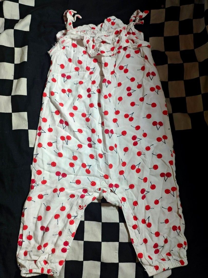 Baby White Cherry Print Jumpsuit Romper Snap Buttons (Category: Jumpsuits) located in Pasig City. Submitted by love_happybee (Listing ID 1464890676, Image 1). Description: - Adorable white baby jumpsuit with all-over red cherry pattern - Easy snap closures down the legs for quick diaper changes - Adjustable tie straps at the shoulders for a custom fit - Lightweight fabric, ideal for warmer weather - Elastic ankles keep the fit secure - Flawless c