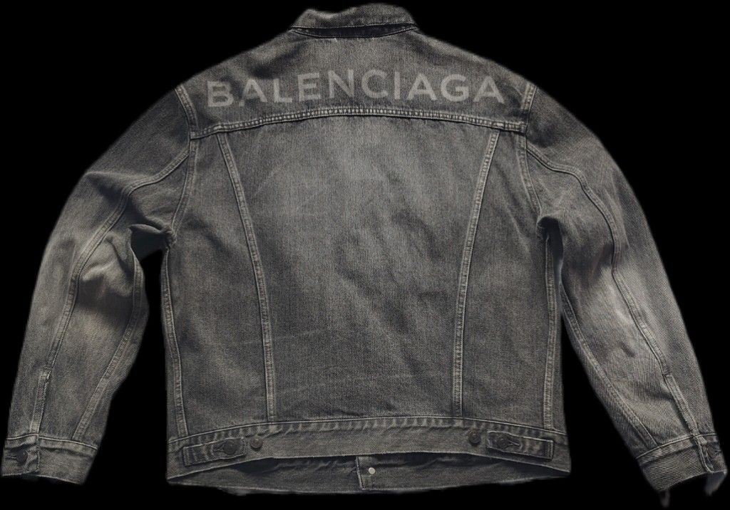 Balenciaga Logo Printed Denim Jacket (Category: Luxury Apparel) located in Kalibo. Submitted by kerrokerropii (Listing ID 1464892876, Image 2). Description: Balenciaga grey washed denim jacket. Classic trucker style with button closure and front pockets. Large Balenciaga lettering printed across the upper back panel. Heavy cotton fabric with intentional vintage distressing throughout. Structured fit with adjustable waist tabs at the hem..