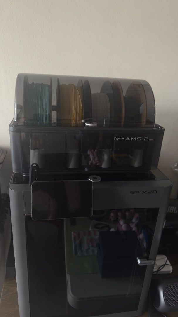 Bambu Lab X2D 3D Printer with AMS 2 Pro (Category: Printers, Scanners & Copiers) located in Manila. Submitted by layerforgeph (Listing ID 1464770583, Image 3). Description: - Model: Bambu Lab X2D 3D Printer - Bundle: Includes AMS 2 Pro multi-material unit and 4 loaded filament spools - Design: Fully enclosed grey body with front touch display panel - Features: High-speed printing setup, perfect for multi-color projects - Inclusions: Everything sh