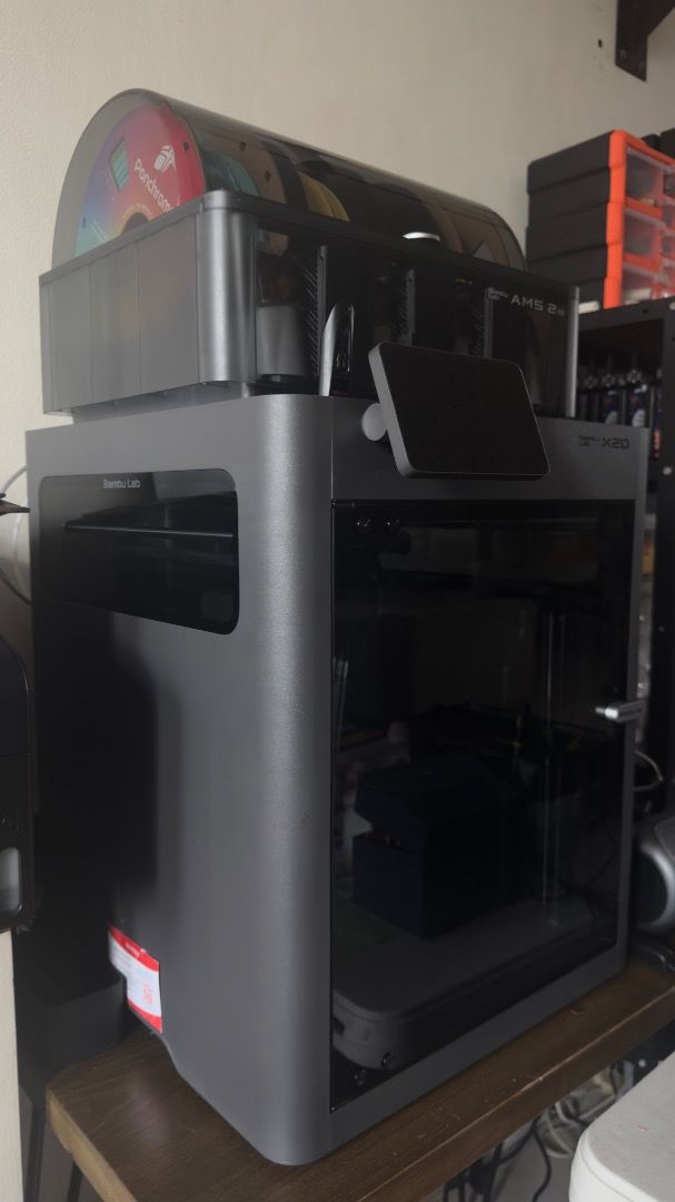 Bambu Lab X2D 3D Printer with AMS 2 Pro (Category: Printers, Scanners & Copiers) located in Manila. Submitted by layerforgeph (Listing ID 1464770583, Image 2). Description: - Model: Bambu Lab X2D 3D Printer - Bundle: Includes AMS 2 Pro multi-material unit and 4 loaded filament spools - Design: Fully enclosed grey body with front touch display panel - Features: High-speed printing setup, perfect for multi-color projects - Inclusions: Everything sh