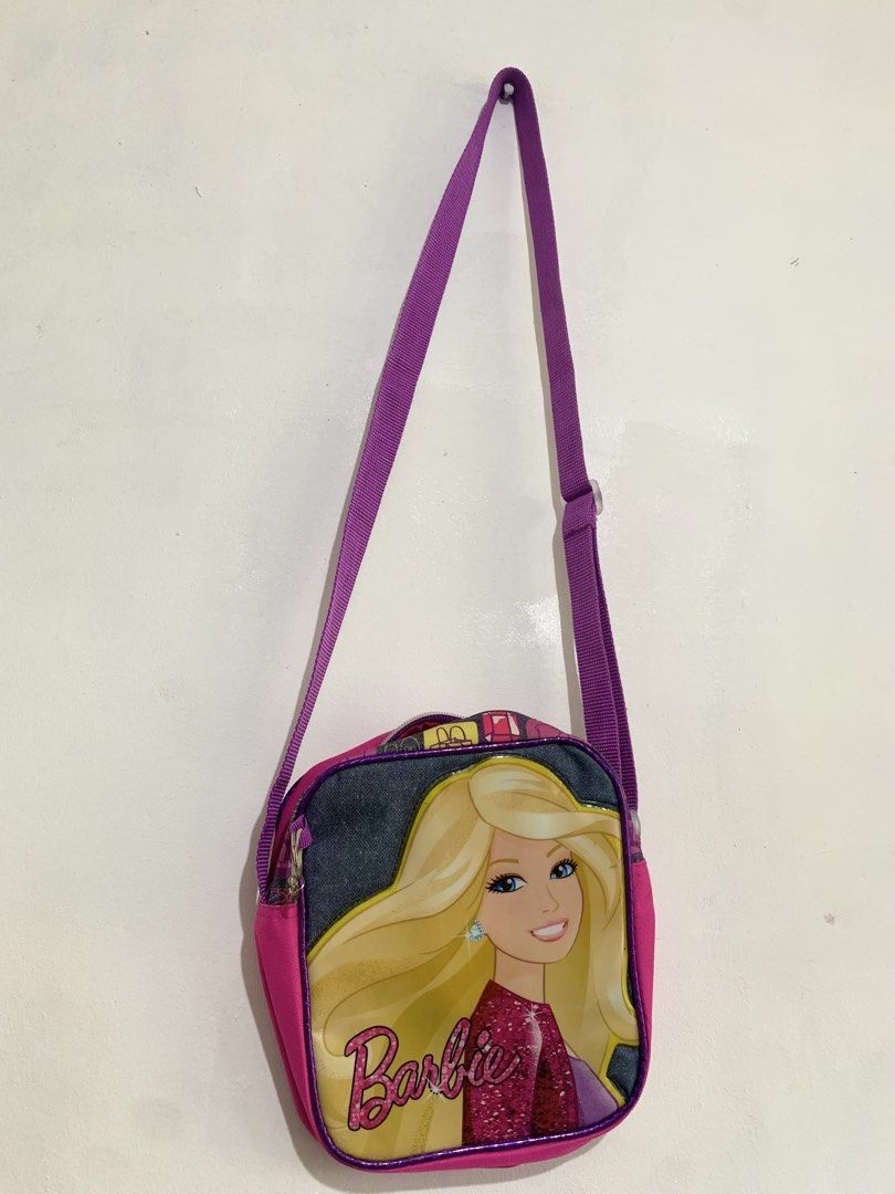 Barbie Pink / Purple Crossbody Shoulder Bag (Category: Babies & Kids Fashion) located in San Pedro. Submitted by kcshops (Listing ID 1464796940, Image 2). Description: Barbie Crossbody / Shoulder Bag 💰 Price: ₱400 - Negotiable ✨ Condition: Pre-loved, good condition 📍 Location: San Pedro, Laguna 🤝 Meet-up: Southwoods Mall, Biñan City 🚚 Delivery: J&T or Lalamove — delivery fee shouldered by buyer 📩 Message me for additional photos, measurement