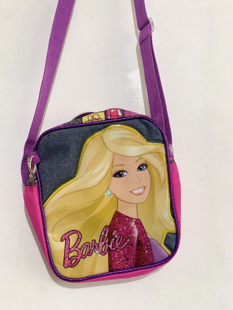 Barbie Pink / Purple Crossbody Shoulder Bag (Category: Babies & Kids Fashion) located in San Pedro. Submitted by kcshops (Listing ID 1464796940, Image 1). Description: Barbie Crossbody / Shoulder Bag 💰 Price: ₱400 - Negotiable ✨ Condition: Pre-loved, good condition 📍 Location: San Pedro, Laguna 🤝 Meet-up: Southwoods Mall, Biñan City 🚚 Delivery: J&T or Lalamove — delivery fee shouldered by buyer 📩 Message me for additional photos, measurement