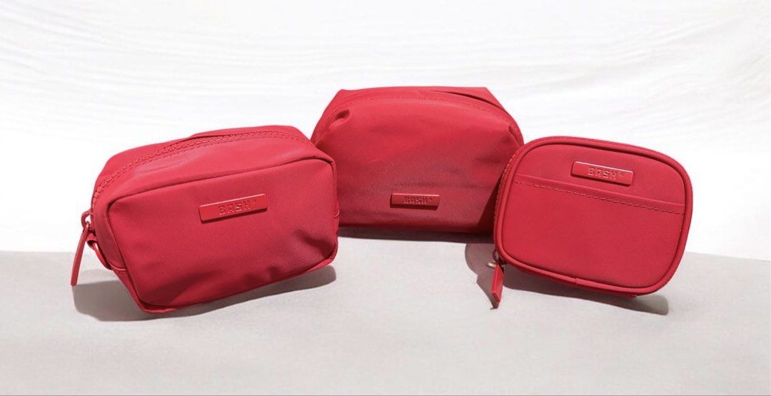 BASH Cosmetic Pouch Set in Ruby Collection (Category: Purses & Pouches) located in Quezon City. Submitted by myaidagratela985464 (Listing ID 1464799737, Image 1). Description: - Brand: BASH - Set of 3 vibrant red cosmetic pouches in varying shapes and sizes - Material: Smooth, durable nylon with clean interiors - Hardware: Matching red zip pulls and chic embossed logo plates - Function: Ideal for organizing makeup, skincare, or daily essentials -