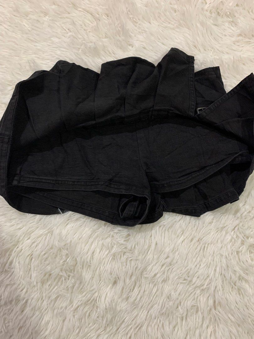 BDG Black Denim Pleated Skort Size XS (Category: Skirts) located in Iba. Submitted by thriftcoyan (Listing ID 1464886576, Image 2). Description: - Brand: BDG - Size: XS - Color: Washed black - Style: Y2K pleated front with side buckle detail - Features: Built-in shorts underneath, side zipper closure - Condition: Great trendy piece, easy to pair with baby tees or boots - Note: Measurements available upon request.