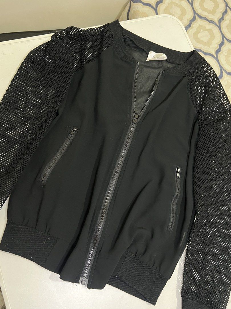 Be Lady Black Mesh Sleeve Zip Bomber Jacket (Category: Coats, Jackets and Outerwear) located in Manila. Submitted by sennisen (Listing ID 1464922834, Image 1). Description: - Brand: Be Lady - Size: F (Free Size) - Color: Black - Style: Lightweight casual bomber jacket - Material/Design: Sheer body fabric with textured mesh sleeves - Features: Full front zip closure, two zipped side pockets, and ribbed knit collar, cuffs, and hem.