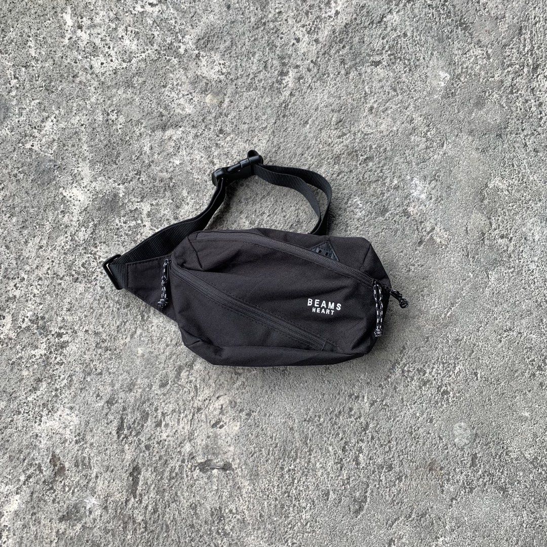Beams Heart Black Waist Bag (Category: Belt bags, Clutches and Pouches) located in Polangui. Submitted by b0ssl00ts (Listing ID 1464807091, Image 1). Description: - Brand: Beams Heart - Material: Sturdy black canvas with white embroidered branding - Storage: Main compartment with a handy diagonal zip pocket - Hardware: Smooth zippers with stylish black and white speckled cord pulls - Fit: Adjustable black strap with a secure plastic buckle closur