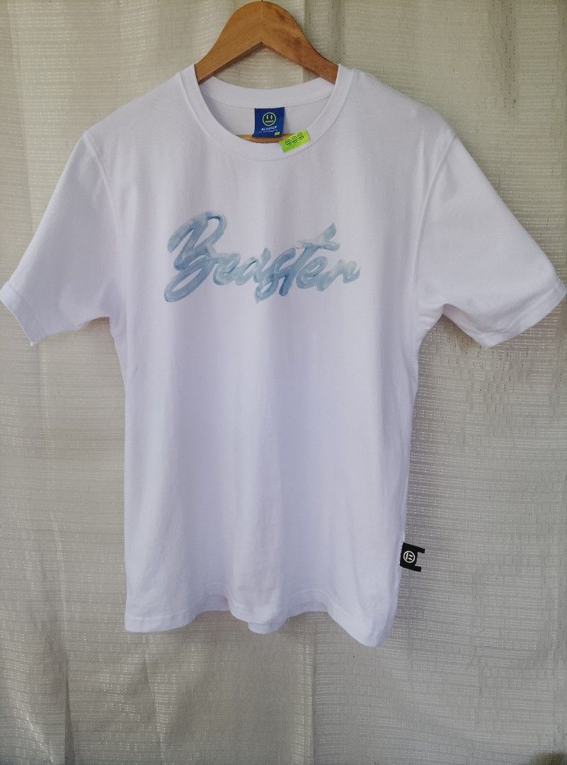 BEASTER White Graphic Tee with Receipt Patch (Category: Tshirts & Polo Shirts ) located in Tayum. Submitted by purephoenix.0f7166 (Listing ID 1464813090, Image 1). Description: - Brand: Beaster - 20.5 x 27 dimes - like new condition - no issue - Color: White with blue accents - Design: Blue brushstroke script logo on front, large blue dripping smiley graphic on back - Details: Faux receipt patch with barcode on back hem, woven sleeve and side tag