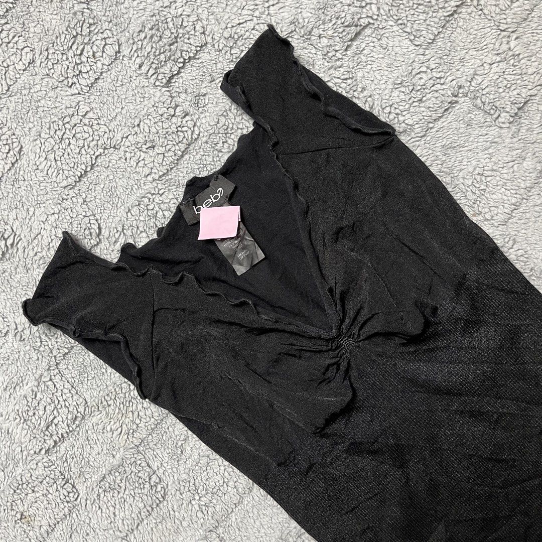 bebe Black Ruffle Trim V-Neck Sleeveless Top (Category: Sleeveless) located in Tarlac. Submitted by thriftspot2024 (Listing ID 1464809211, Image 2). Description: - Brand: bebe - Size: P/S - Color: Black - Style: Y2K aesthetic, sleeveless, ruffled V-neck, center ruching, ribbed lower body - Material: 92% nylon, 8% spandex - Origin: Made in U.S.A..