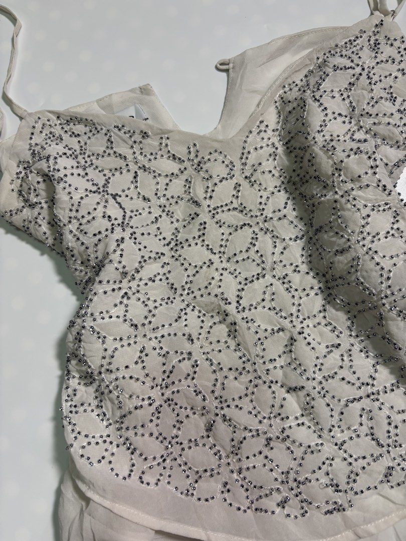 BEBE white camisole embellished shimmering beadwork soft ruffled hem top (Category: Others Tops) located in Davao. Submitted by loveeandco (Listing ID 1464856450, Image 3). Description: has flaws.