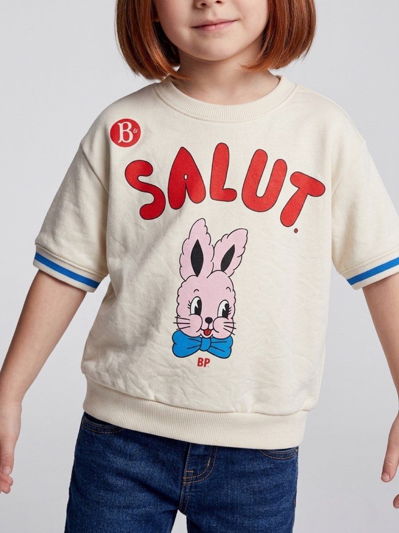 Bebedepino short-sleeve sweatshirt (Category: Babies & Kids Fashion) located in Cebu City. Submitted by yjainani (Listing ID 1462373381, Image 1). Description: cream-colored Bebedepino short-sleeve sweatshirt featuring a cute pink bunny graphic and bold red "SALUT" lettering.