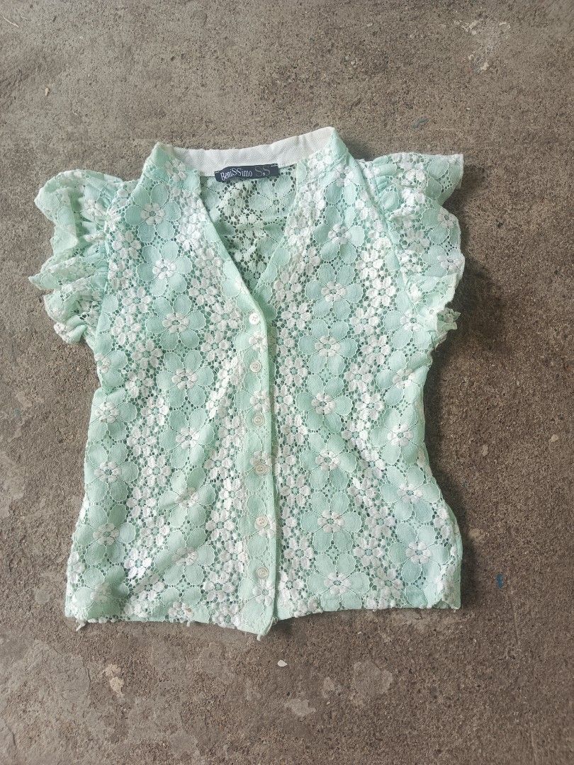 BeniSSimo Lace Blouse Mint Green (Category: Blouses) located in Manila. Submitted by anjo1 (Listing ID 1464878376, Image 1). Description: - Brand: BeniSSimo SS - Color: Mint green with a floral lace pattern - Details: V-neckline, white contrasting collar band, 5 white front buttons - Sleeves: Short flutter sleeves - Material: Lightweight, ideal for warm weather - Styling: Great to pair with high-waisted skirts and jeans.