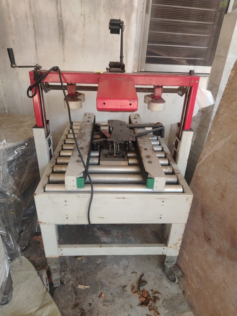 BestPack Carton Sealer Packaging Machine (Category: Industrial Equipment) located in Quezon City. Submitted by nhatedaniel2293164 (Listing ID 1464932821, Image 2). Description: - Heavy-duty BestPack carton sealer ideal for warehouse and shipping operations - Built with a durable metal frame, roller conveyor deck, and red top assembly with tape head - Equipped with an adjustable height handle for comfortable use - Mounted on swivel wheels with bra
